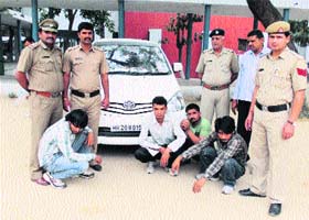 The arrested gangsters along with the seized Innova car in Sonepat