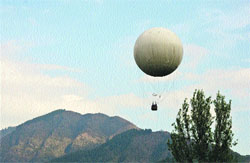 Tourists enjoy a balloon ride on the banks of the Dal Lake in Srinagar on Monday. 