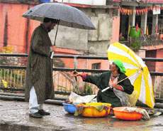 A woman sells fish on the Amira Kadal bridge in Srinagar on Monday.