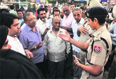 Police officials try to pacify shopkeepers at Aarti Chowk.
