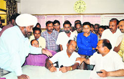 URMU leaders argue with the Chief Yard Master (centre) at the railway station in Ludhiana.