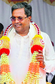 Siddaramaiah being greeted by MLAs after he was sworn in as the new Chief Minister of Karnataka by Governor HR Bhardwaj in Bangalore on Monday. 