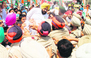 Angry Punjab Youth Congress activists try to breach a police cordon during a protest outside the SSPs office in Tarn Taran on Monday. 