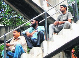 Unemployed youths sitting atop a water tank during their protest in Amritsar.