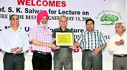 Vice-Chancellor of Central University of Punjab, Dr Jai Rup Singh (second from left), honours Prof Moin Uddin by presenting a memento in Bathinda on Tuesday
