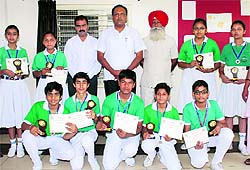 The Lord Rama team that lifted the table tennis title with the principal and members of the staff