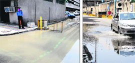 A security guard covers his face due to foul smell emanating from accumulated water near the Gastroenterology Centre; a waterlogged road outside the Directors office
