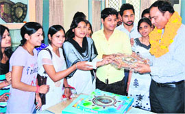 Newly appointed SMJN Principal Navneet Kumar Ghildiyal being welcomed by students in Haridwar on Tuesday. 