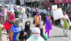 Teachers take out a silent procession in Dehradun on Tuesday. 
