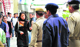 Cops check identity cards of students at the entry gate of HPU in Shimla on Tuesday.
