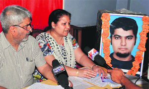 The parents of Akshay Verma, who was found dead on a railway track last year, in Jammu on Tuesday. 