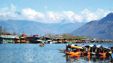 Shikara owners wait for tourists on the Dal Lake in Srinagar on Tuesday. 