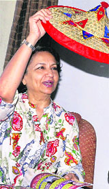 Actress Sharmila Tagore receives an Assamese japi in Guwahati on Tuesday. 