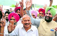 PPCC chief Partap Singh Bajwa (right) and MLA Brahm Mohindra at an election rally in a Patiala village on Tuesday