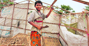 A boy dismantles his tent ahead of cyclone in Sittwe, Myanmar, on Tuesday. 