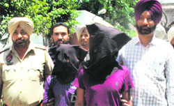 Two Bihar residents arrested by the police for possessing narcotic substances in Amritsar on Wednesday. Tribune photo: Sameer Sehgal