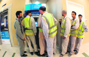 Indian workers line up at an ATM in Dubai. Indias cyber watchdog is investigating how the computer systems of two firms were breached in a global ATM heist that saw $45 million stolen from two Middle East banks. 