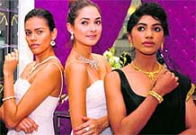 models (right) exhibit jewellery at the opening of a store in Bathinda on Wednesday
