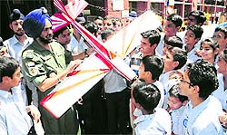 Students look at the model of an aeroplane during the NCC enrolment campaign at Government Model Senior Secondary School in Sector 20; and (right) students take part in an inter-school mathematics and computer event at St Xaviers Senior Secondary School, Sector 44-C, Chandigarh, on Wednesday