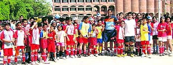 Players in a jubilant mood after receiving their medals during the Asian Football Confederation Grassroots Day celebrations at St Stephens School, Sector 45, in Chandigarh on Wednesday