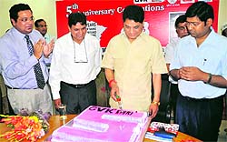 Health Minister Surinder Singh Negi celebrates the completion of five years of EMRI service in Uttarakhand by cutting a cake in Dehradun on Wednesday