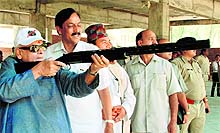 Governor Aziz Qureshi takes an aim at the bulls eye during a visit to Jaspal Rana Institute of Shooting and Sports at Paundha, on the outskirts of Dehradun, on Wednesday