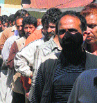 Quake victims line up to receive government aid in Bhaderwah.