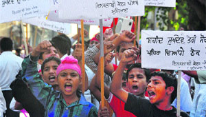 Students of government schools take part in a rally organised by Inquilabi Kender, Punjab, on Shaheed Sukhdev Thapars birth anniversary in Ludhiana on Wednesday. 