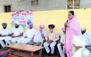 A woman candidate campaigns at Rampur village on Wednesday. 