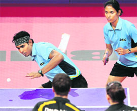 Indias Sharath Kamal and Shamini Kumaresan play against Germanys Patrick Franziska and Petrissa Solja in the second round of the mixed doubles. 