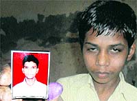 A rescued child shows the picture of the contractor, Arwind Jaiswal, who brought them from Bihar to Amritsar, on Thursday