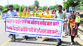 Teachers hold a protest march at Sector 17 in Chandigarh on Thursday.