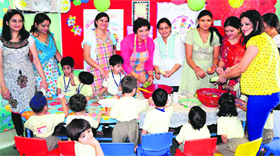 Mothers prepare fruit chat for their kids at Saupins School in Sector 32, Chandigarh, on Thursday.