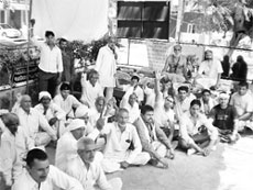 Sant Rajgiri Maharaj (bare chested) on an indefinite fast in front of the Mini-Secretariat, Sonepat, on Thursday