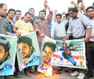 Members of the Yuvaa Shakti Sangh burn posters of Indian cricketer S Sreesanth after news broke out about his involvement in spot fixing in Jalandhar on Thursday.