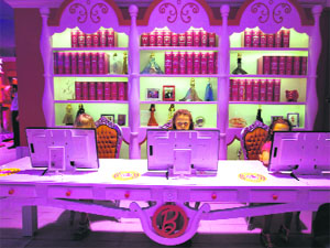 Children play with computers inside Barbie Dreamhouse of Mattel's Barbie dolls in Berlin on Thursday.