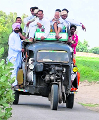 An overloaded transport vehicle plies on the Bathinda-Lambi road.