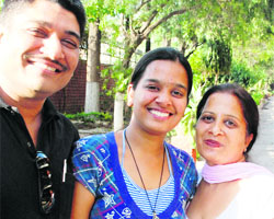 Aastha Rajan, a Class X student of Little Flower Convent School, with her parents in Panchkula on Friday.