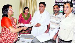 Kusal Singh, an independent candidate, submits his nomination papers for the MC elections to Hema Sharma, SDM, in Karnal on Friday