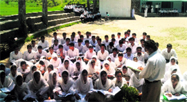 Teachers take classes in an open ground at Government Higher Secondary School, Lassana, in Surankote.