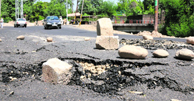 A portion of the Canal road towards Bhagwati Nagar that caved in, in Jammu on Friday.