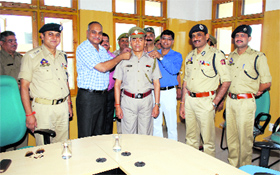 Director General of Prisons K Rajendra Kumar, along with Deputy Commissioner, Jammu, Ajit Kumar Sahu decorates a head warder in Jammu on Friday.