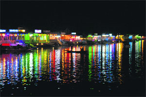 Lights of houseboats are reflected on the waters of the Dal Lake in Srinagar on Friday. 