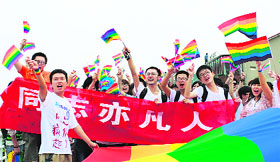 Youngsters hold rainbow flags, a symbol for gays, as they march during an anti-discrimination parade on International Day Against Homophobia at Changsha in China's Hunan province on Friday. 