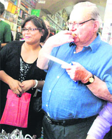 Ruskin Bond enjoys a cake on his 79th birthday in Mussoorie on Saturday. 