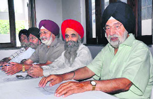 Members of the Sri Guru Singh Sabha, Dehradun, address a press conference in Dehradun on Saturday.