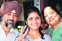 Jasdeep Kaur with her parents in a jubilant mood after securing top positions in PSEB examinations in Jalandhar