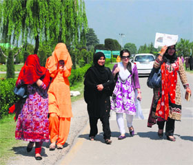  Kashmir University students cover their faces to protect themselves from the scorching heat in Srinagar on Saturday.