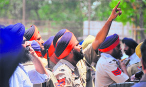 Policemen check the duty chart ahead of the zila parishad and panchayat samiti polls in Ludhiana on Saturday. 