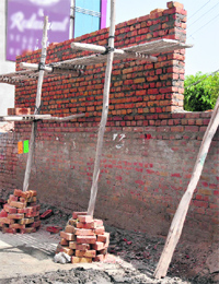 The construction of an illegal boundary wall was stopped as the owner of the plot failed to produce the approved building plan, in Bathinda on Sunday.